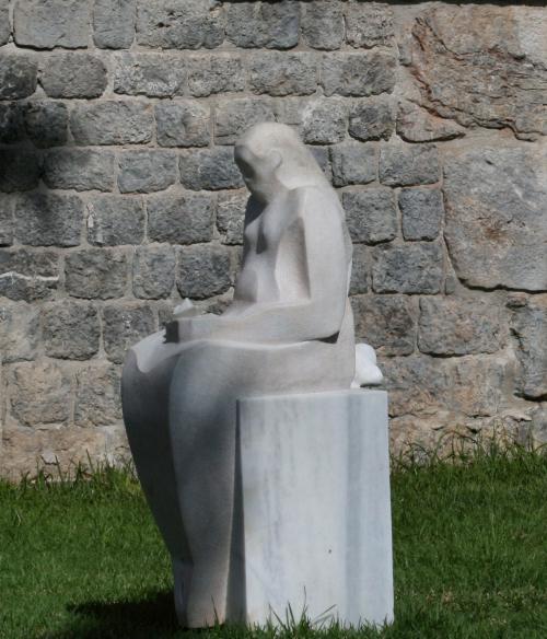 Statue of person sitting down